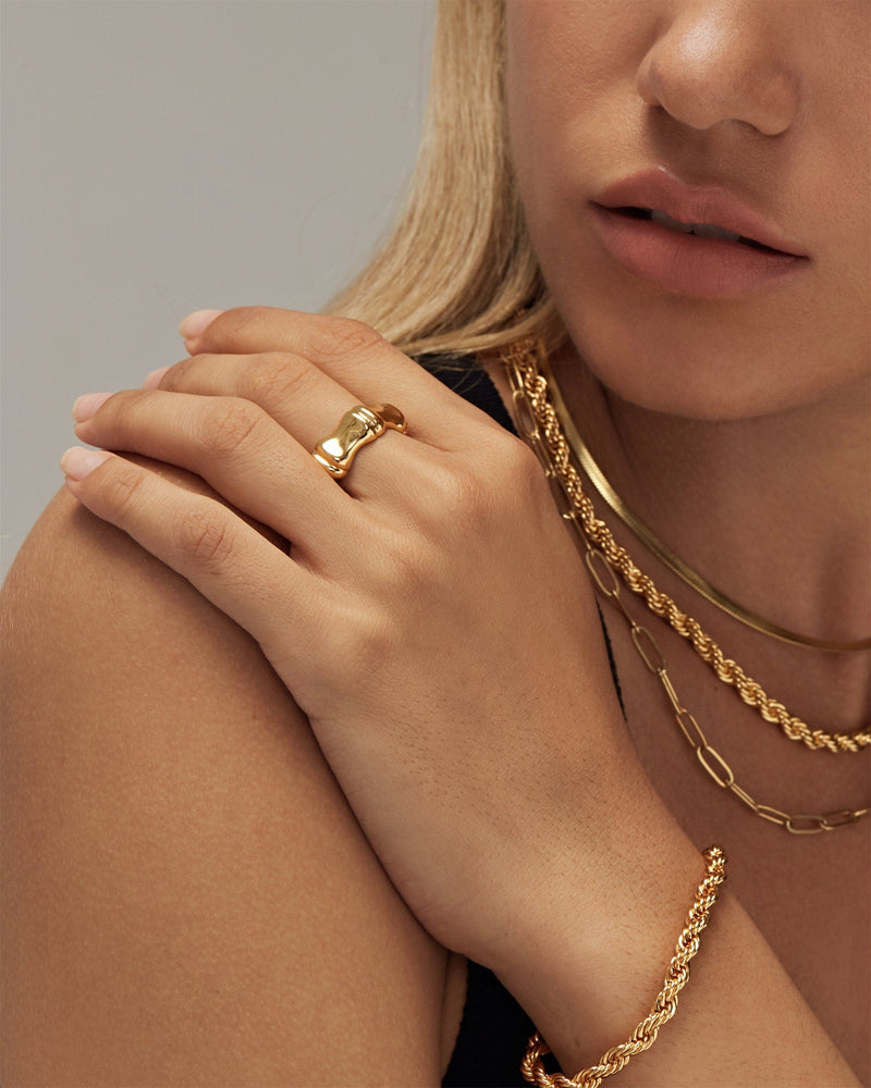VARELTI gold-tone sterling silver ring and layered necklaces worn by a model