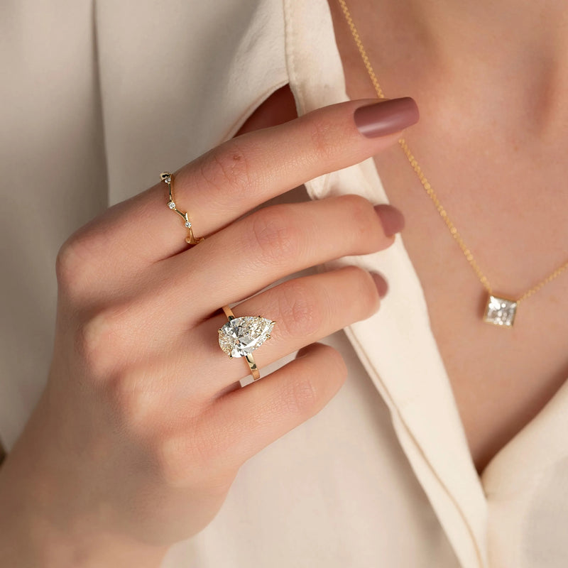 VARELTI three-stone moissanite ring worn on hand